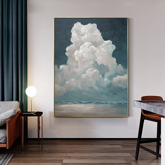 May include: An oil painting of a large, fluffy white cloud against a dark blue sky. The cloud is the focal point, with a hint of a seascape below. The artwork is framed in gold and evokes a sense of tranquility.
