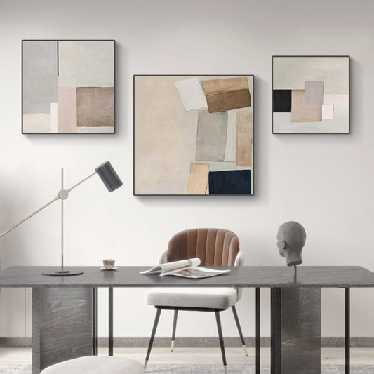 May include: Three abstract art prints with geometric shapes in shades of brown, beige, white, and black. The prints are framed in black and hung on a white wall.