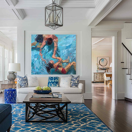 May include: A painting of three people swimming in a pool. The painting is in a living room with a white couch, a coffee table, and a blue rug.
