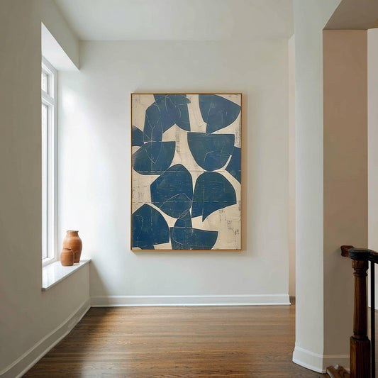 May include: A large rectangular wall art piece featuring a series of dark blue geometric shapes, including semi-circles and irregular forms, arranged against a textured off-white background. The artwork is enclosed in a thin wooden frame.
