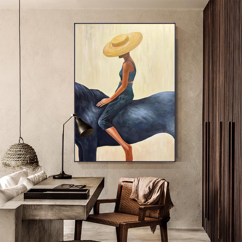 May include: An abstract painting depicts a person riding a dark blue horse. The person wears a blue outfit and a wide-brimmed straw hat. The background is a light yellow color.