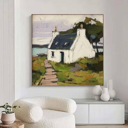 May include: A square oil painting on canvas depicting a white cottage with a dark blue roof situated in a green landscape. A stone path leads to the house, with a body of water in the background under a pale sky. The artwork features thick brushstrokes.