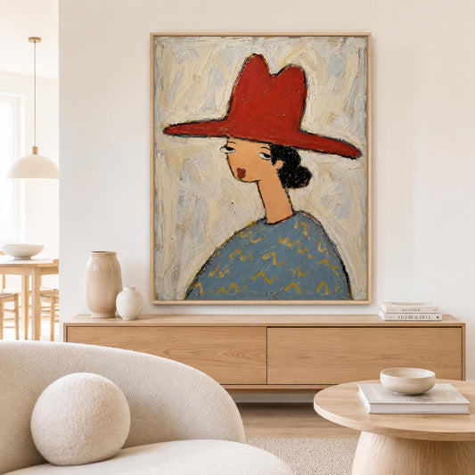 May include: A framed oil painting on canvas depicting a stylized figure wearing a wide-brimmed red hat and a blue patterned shirt. The figure has dark hair, a long neck, and a neutral expression, set against a textured, light-colored background.