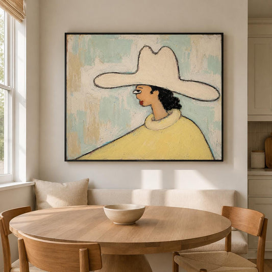 May include: A framed painting depicting a profile view of a figure wearing a wide-brimmed cream-colored hat and a yellow sweater. The figure has dark hair and is set against a textured, light blue and off-white background with visible brushstrokes.