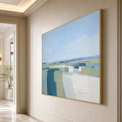 Coastal Reverie hand-painted ocean blue, ivory and soft neutral tones textured coastal landscape painting shown with silver frame