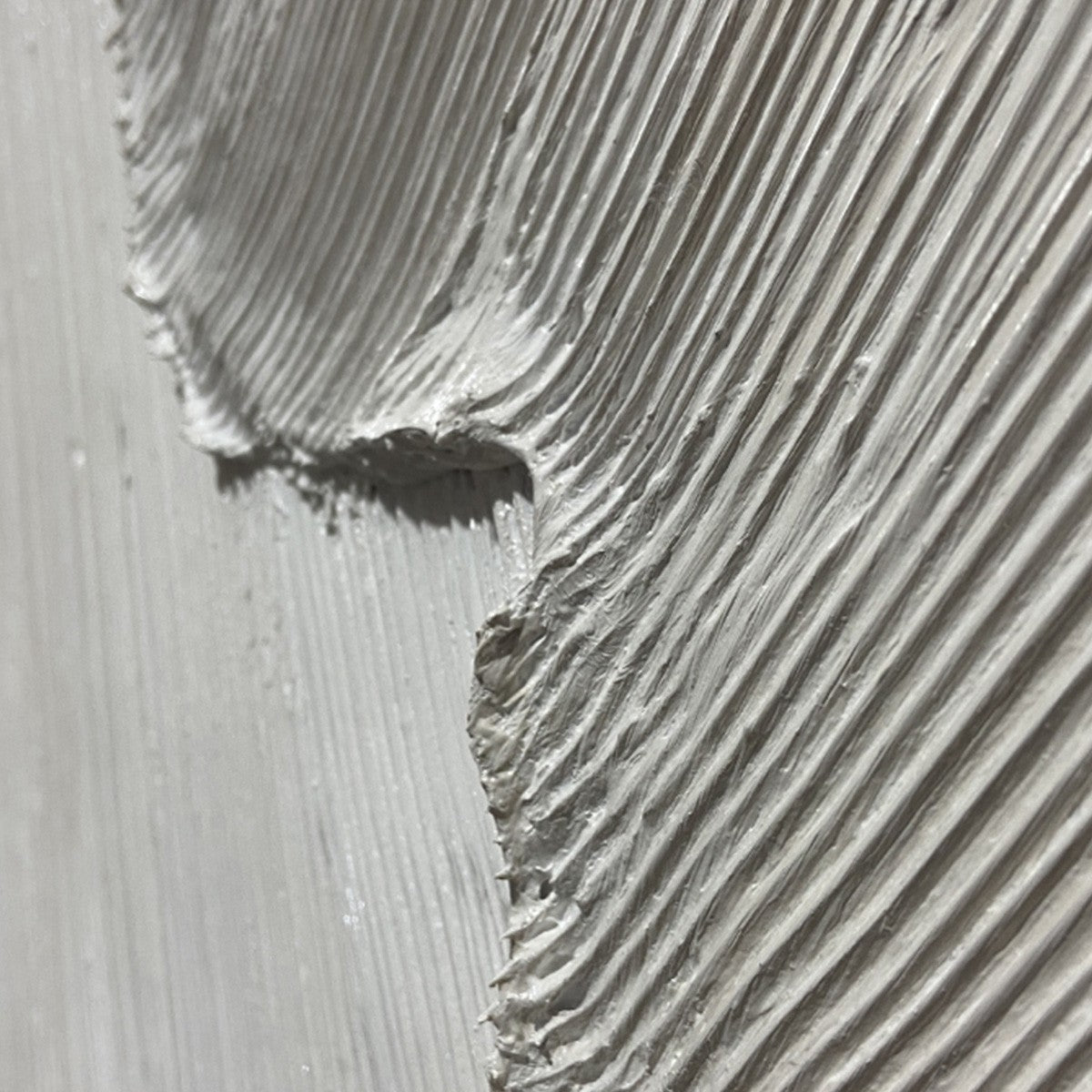 Etched In Stone hand-painted white and soft beige textured ocean wave painting shown with silver frame