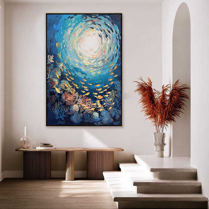 Ocean’s Grace hand-painted gold and coral textured school of fish painting shown with black frame