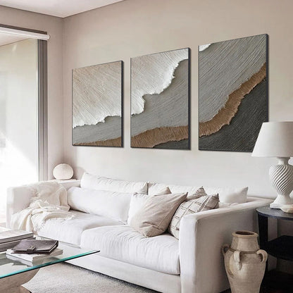 Terra Firma hand-painted beige, soft grey, charcoal and earth brown textured coastal abstract painting shown with gold frame