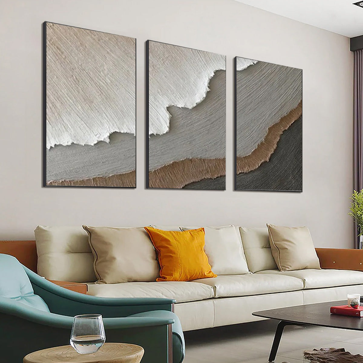 Terra Firma hand-painted beige, soft grey, charcoal and earth brown textured coastal abstract painting shown with silver frame