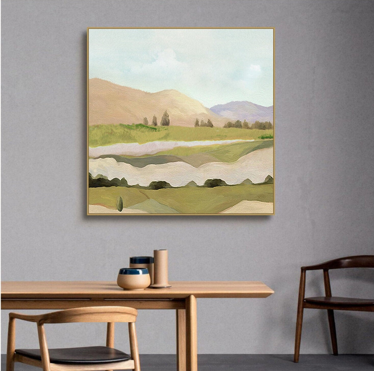 May include: Abstract landscape painting with a gold frame. The painting features a green and brown landscape with hills, trees, and a river. The sky is a light blue with white clouds.