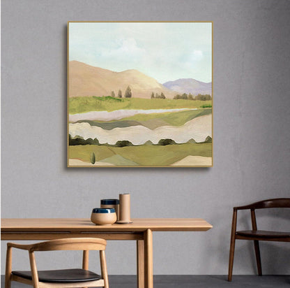 May include: Abstract landscape painting with a gold frame. The painting features a green and brown landscape with hills, trees, and a river. The sky is a light blue with white clouds.