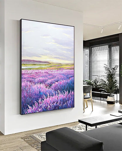 May include: A painting of a lavender field with a light blue sky and a few white clouds. The field is in the foreground and the sky is in the background. The painting is framed in a black frame.
