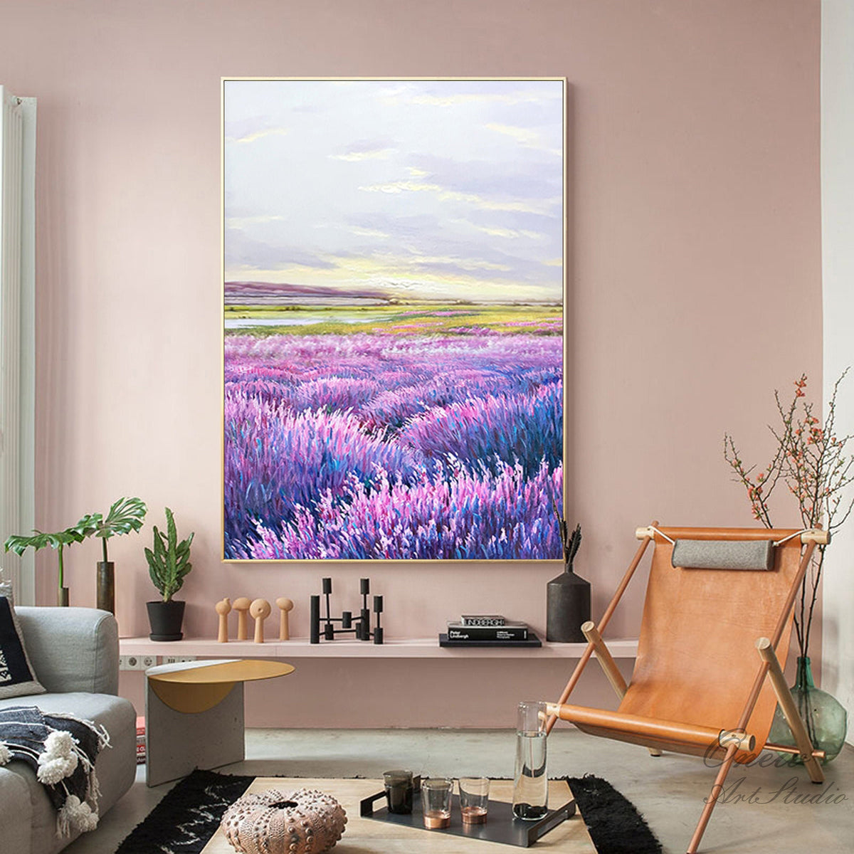 May include: A painting of a field of purple lavender flowers with a lake and hills in the background. The sky is a light blue with white clouds.