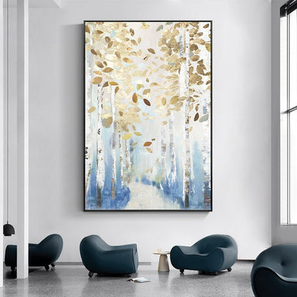 May include: Large framed abstract art print featuring a forest scene with white birch trees, blue and white accents, and gold leaf details. The artwork is displayed in a modern interior setting with blue chairs.