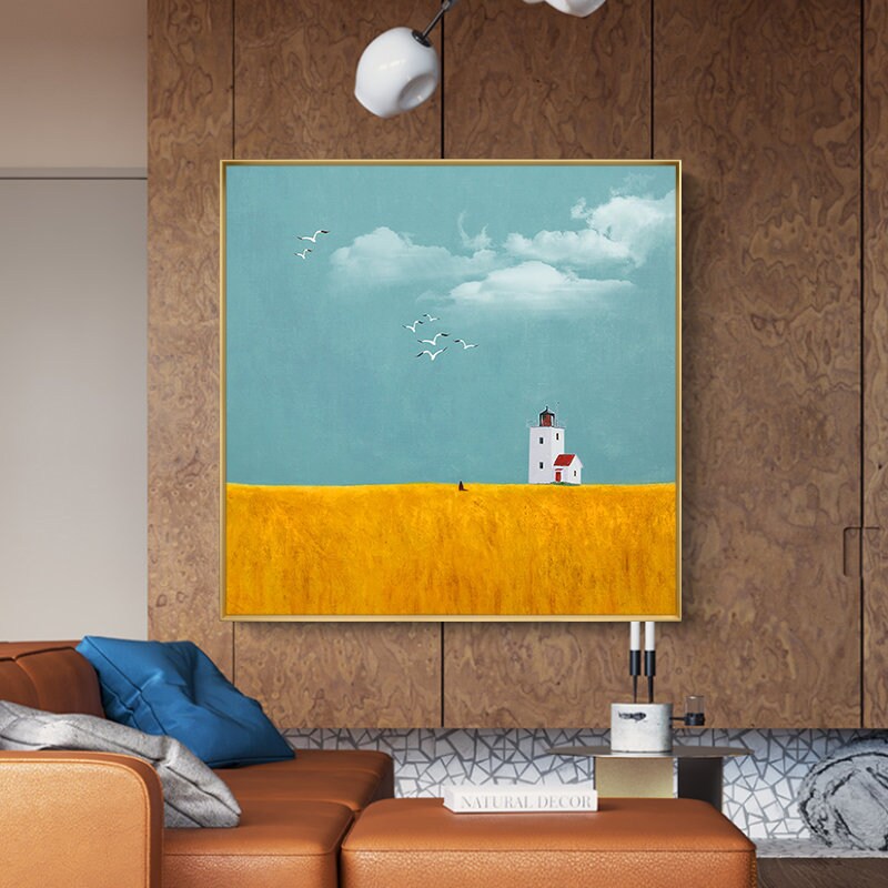 May include: A painting of a white lighthouse with a red roof on a yellow field with a blue sky and white clouds. There are birds flying in the sky.