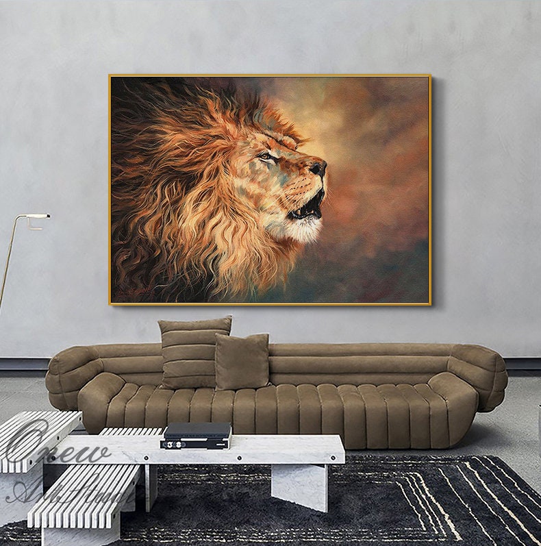 May include: A framed painting of a roaring lion with a golden mane. The artwork features warm tones of brown, orange, and gold, creating a dramatic and powerful image. The lion's open mouth and intense gaze convey strength.