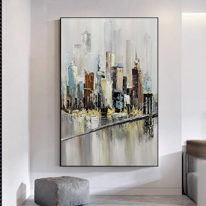 May include: Abstract painting of a cityscape with a bridge in the foreground. The buildings are painted in shades of gray, brown, and blue, with a white background. The bridge is painted in a light brown color, with a gray river below.