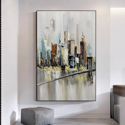 May include: Abstract painting of a cityscape with a bridge in the foreground. The buildings are painted in shades of gray, brown, and blue, with a white background. The bridge is painted in a light brown color, with a gray river below.