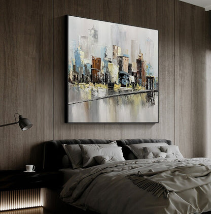 May include: Abstract painting of a cityscape with a river in the foreground. The painting is done in shades of gray, blue, brown, and yellow. The buildings are stylized and the river is reflective.
