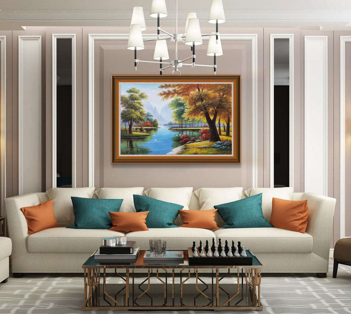May include: A framed painting of a forest scene with a river running through it. The trees are in autumn colors, with red, orange, and yellow leaves. The river is blue and there are white birds flying over it. The painting is hanging on a wall in a living room with a white sofa and orange and teal pillows.