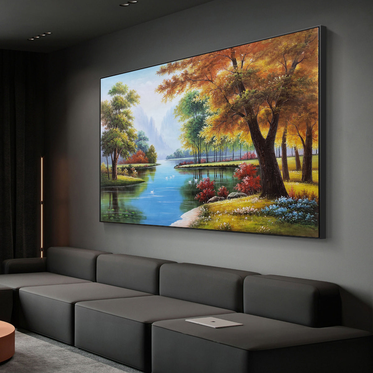May include: A painting of a serene landscape with a river winding through a forest. The trees are in shades of green, yellow, and orange, and the water is a bright blue. The painting is framed in black.