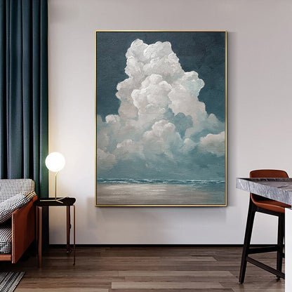 May include: An oil painting of a large, fluffy white cloud against a dark blue sky. The cloud is the focal point, with a hint of a seascape below. The artwork is framed in gold and evokes a sense of tranquility.