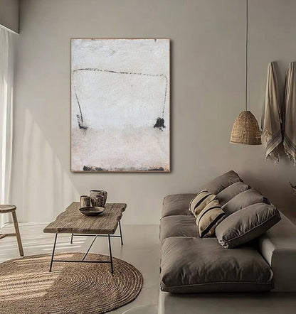 May include: Abstract painting with black lines and shapes on a white background. The painting is hanging on a wall in a living room setting with a couch and a coffee table.