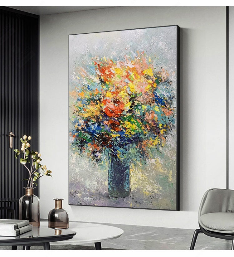 May include: A colorful abstract painting of a bouquet of flowers in a blue vase. The flowers are painted in a variety of colors, including red, yellow, blue, and green. The background is a light gray color.