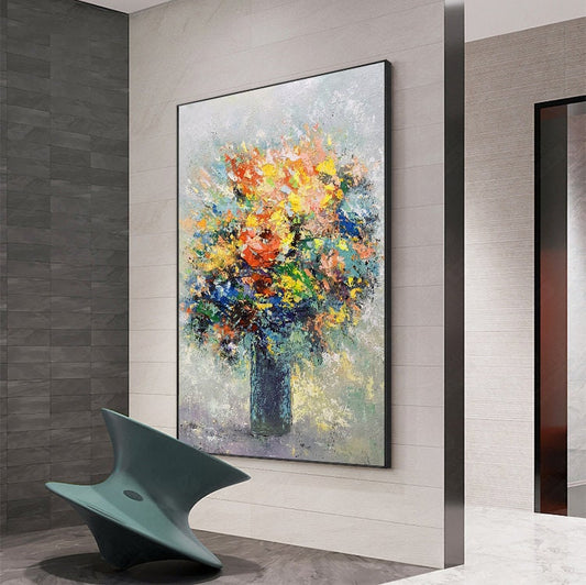 May include: A colorful abstract painting of a bouquet of flowers in a blue vase. The flowers are painted in a variety of colors, including red, yellow, orange, pink, and blue. The background is a light gray color.