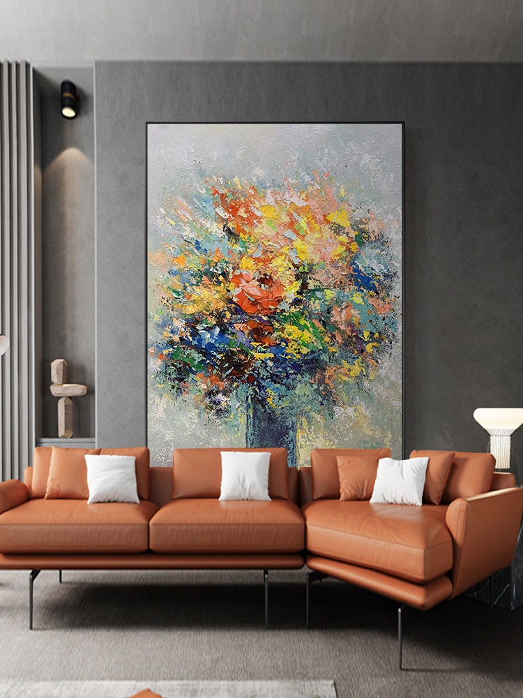 May include: A large abstract painting of a colorful bouquet of flowers in a blue vase. The painting is done in a textured style with thick brushstrokes. The background is a light gray.