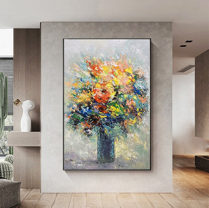 May include: A colorful abstract painting of a bouquet of flowers in a vase. The flowers are painted in shades of yellow, orange, red, blue, and green. The vase is a dark blue color.