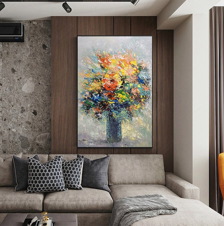 May include: A colorful abstract painting of a bouquet of flowers in a blue vase. The flowers are painted in a variety of colors, including red, yellow, orange, pink, and blue. The background is a light gray color.