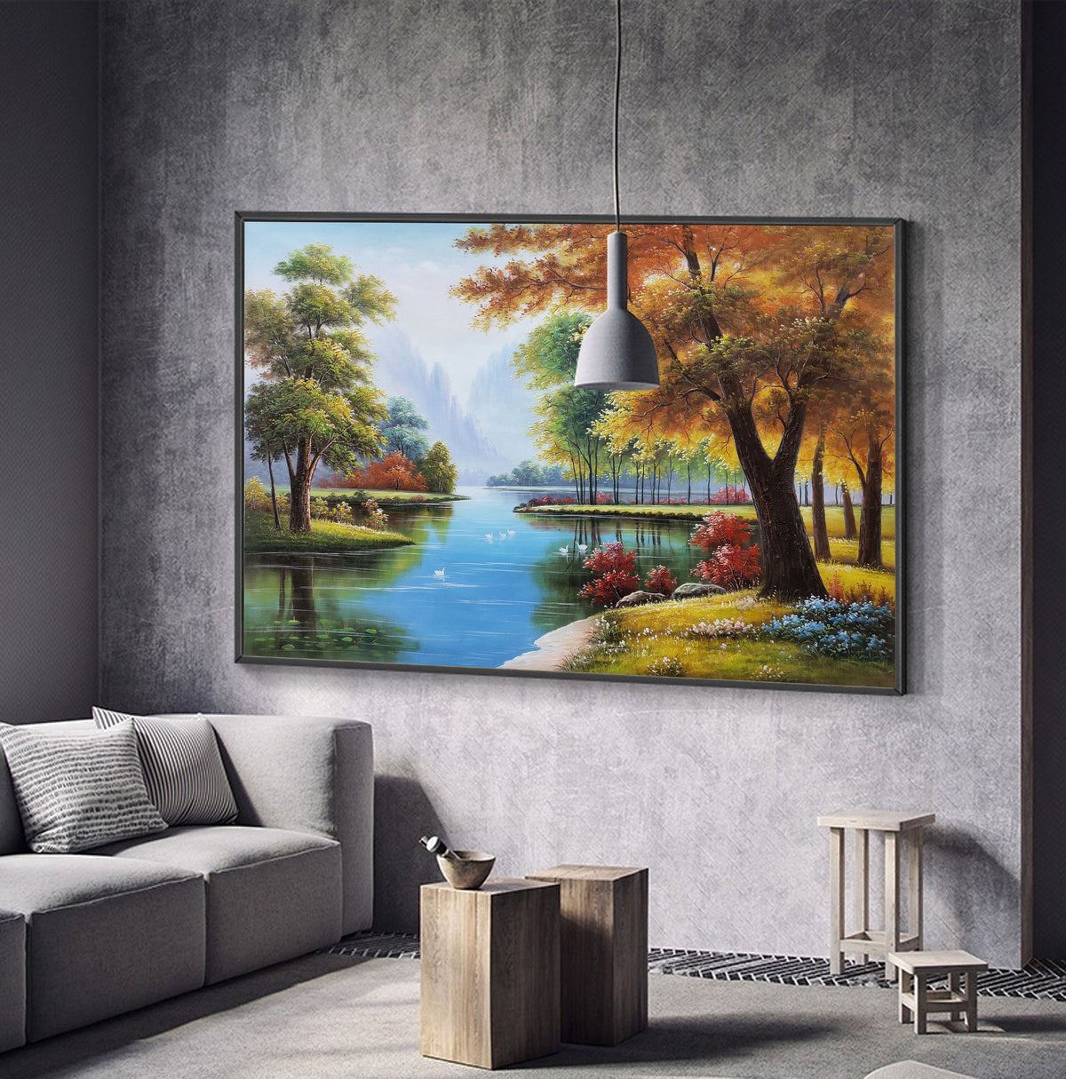 May include: A framed painting of a landscape with a river, trees, and a blue sky. The trees are in shades of green, yellow, and orange. The river is blue and reflects the sky. There are white birds swimming in the river.