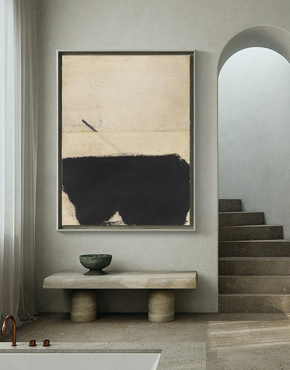 May include: A framed abstract painting with a black and beige color scheme. The painting features a large black shape in the bottom half of the frame, with a thin line extending from the top of the shape to the top of the frame.
