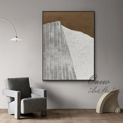 May include: Abstract painting with a white and brown color scheme. The painting features a textured white surface with a geometric pattern in the center. The painting is framed in a black frame.