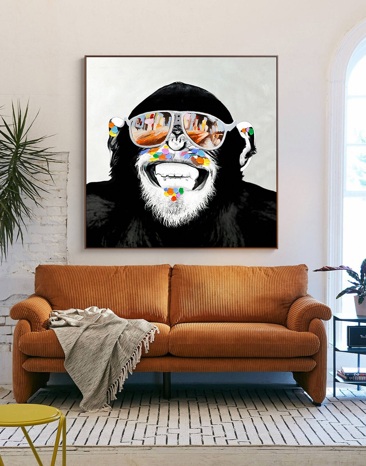 May include: A black and white illustration of a monkey wearing sunglasses with a colorful paint splatter design around its mouth. The monkey is smiling.