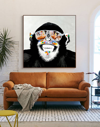 May include: A black and white illustration of a monkey wearing sunglasses with a colorful paint splatter design around its mouth. The monkey is smiling.