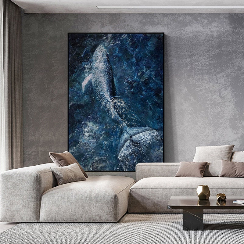 May include: A large, white whale breaches the surface of the ocean, creating a spray of water. The whale is silhouetted against a dark blue background, with a hint of light blue in the water.