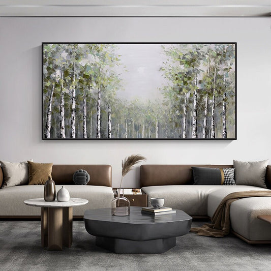 May include: A painting of a forest with tall, slender trees with white bark. The trees are painted in a muted green and white color palette, with a soft, hazy background. The painting is framed in a black frame and hangs on a white wall.