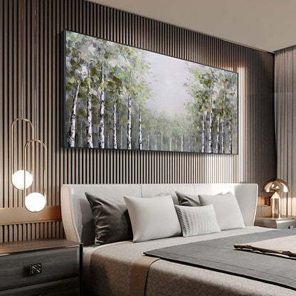 May include: A large, rectangular canvas painting depicting a forest scene with a muted color palette. The painting features a group of birch trees with white bark and green leaves, set against a hazy background. The painting is framed in black and hangs on a wall with vertical wood paneling.