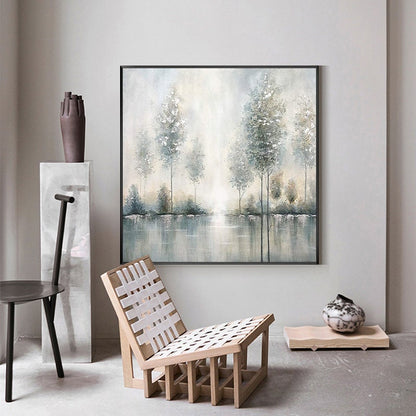 May include: A framed painting of a misty forest scene with trees reflected in a still body of water. The painting is in shades of gray, blue, and white.