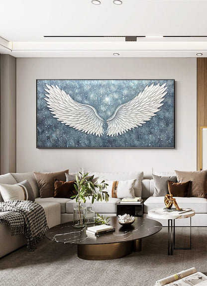 May include: A large canvas print featuring a pair of white angel wings against a blue and silver background. The wings are textured and appear to be 3D.
