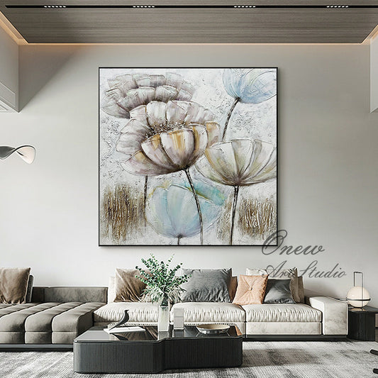 May include: A painting of abstract flowers in shades of white, brown, and blue. The flowers are painted in a textured style, giving the painting a three-dimensional look. The background is a light gray color.