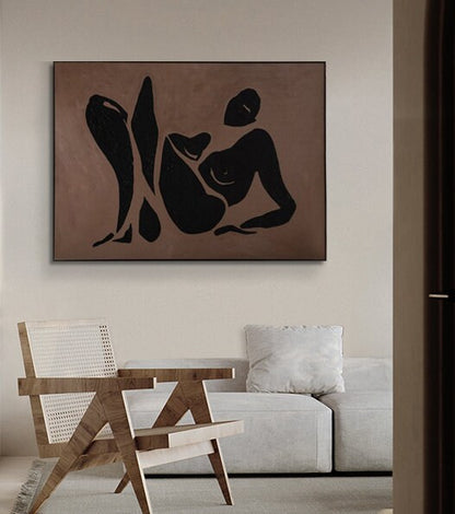 May include: Abstract art print featuring a black silhouette of a person in a reclining pose on a brown background.