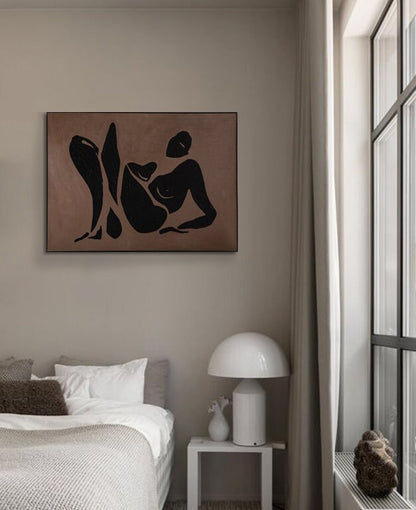 May include: A black and white abstract line drawing of a person in a reclining pose on a brown background. The drawing is framed and hanging on a wall in a bedroom.