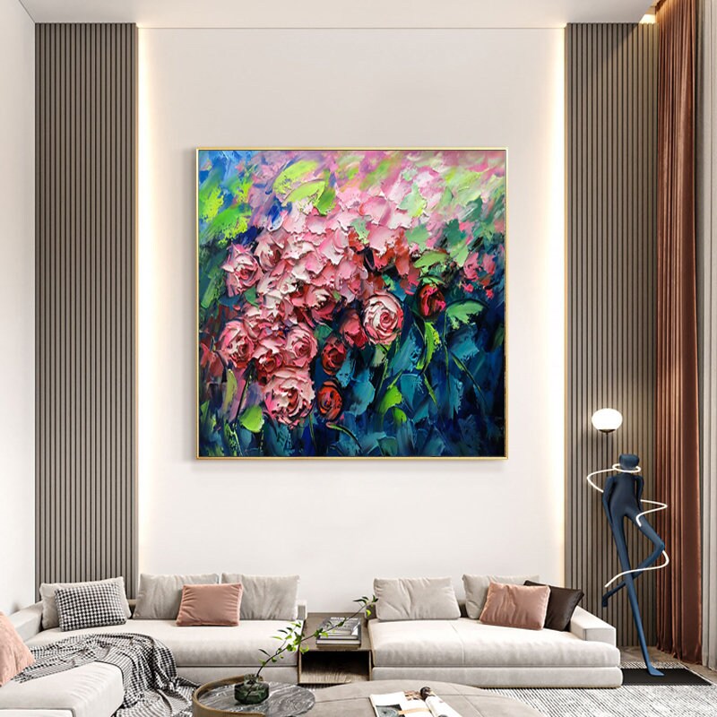 May include: A painting of a bouquet of pink and red roses with green leaves against a blue background. The painting is done in a thick, impasto style, giving it a textured look.