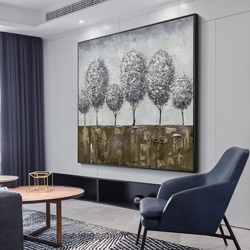 May include: Abstract painting of a row of six gray trees with white accents on a brown and gray background.