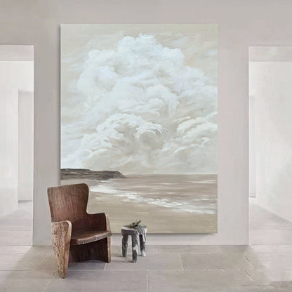 May include: A large abstract painting depicting a seascape with a white cloud formation above a sandy beach and ocean. The painting is in shades of beige, brown, and white.
