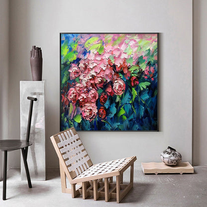 May include: A painting of a bouquet of pink roses with green leaves against a blue background. The painting is framed in black and is hanging on a wall.