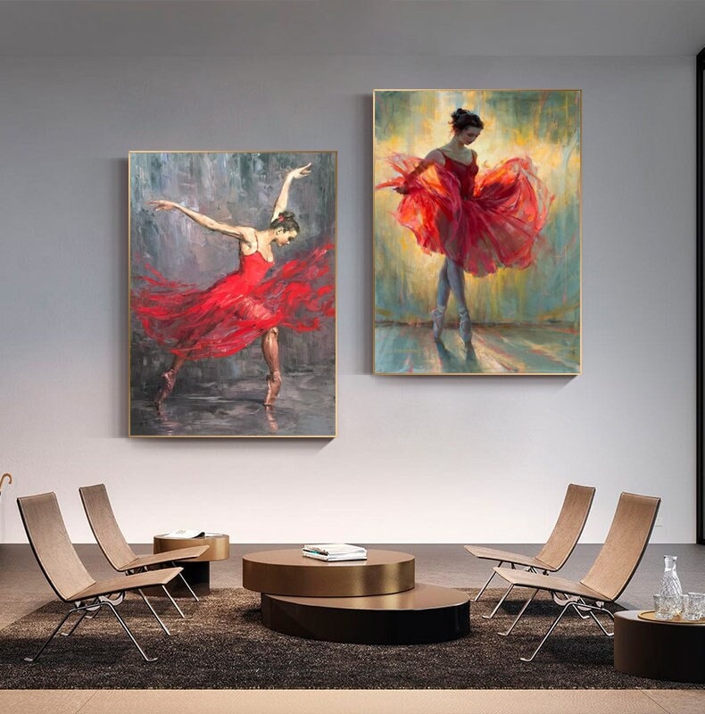 May include: Two paintings of ballerinas in red dresses. The ballerinas are posed in mid-dance, with their skirts flowing around them. The paintings are set against a background of soft colors.